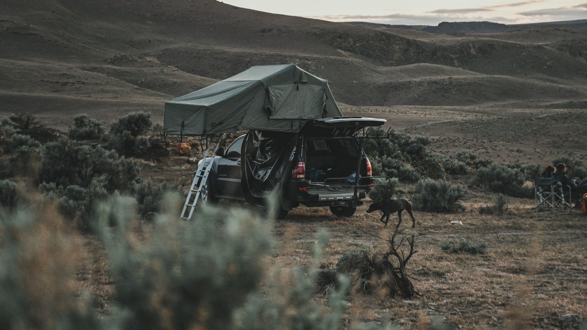 Family relaxing near RV during a Southern Utah trip